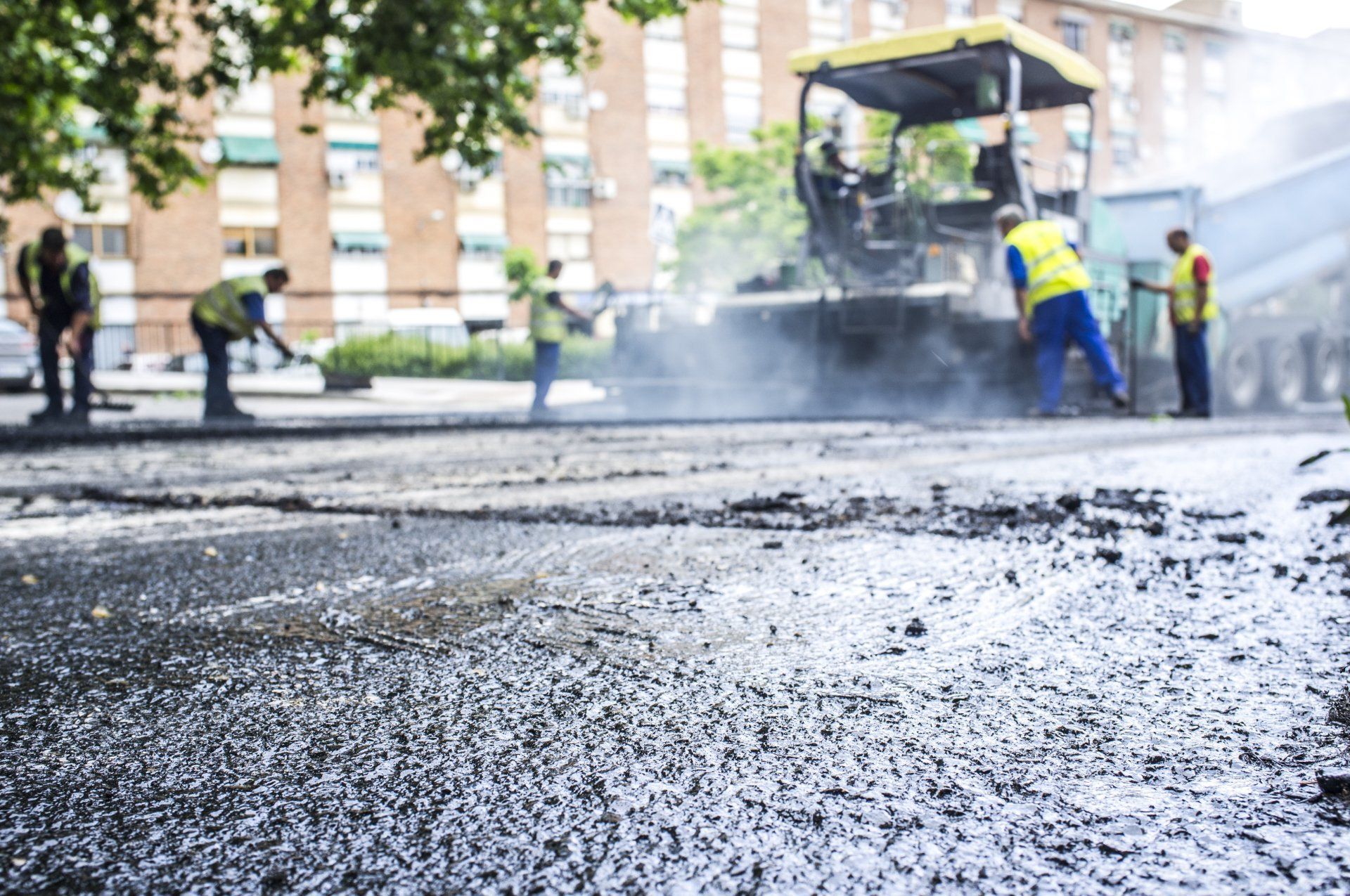 Asphalt Repairs - Road Workers Helping Each Other Repairing Asphalt in Fredericksburg, VA