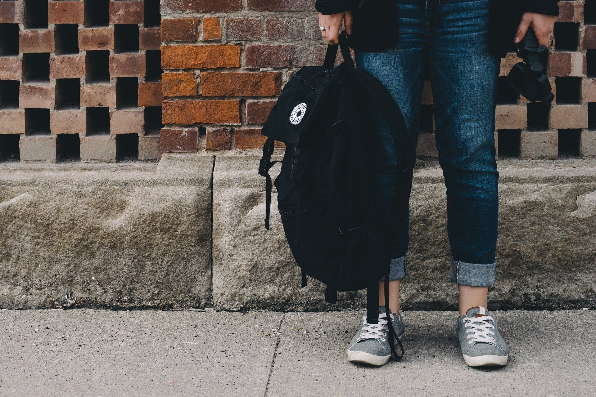 Legs and feet of teen with backpack