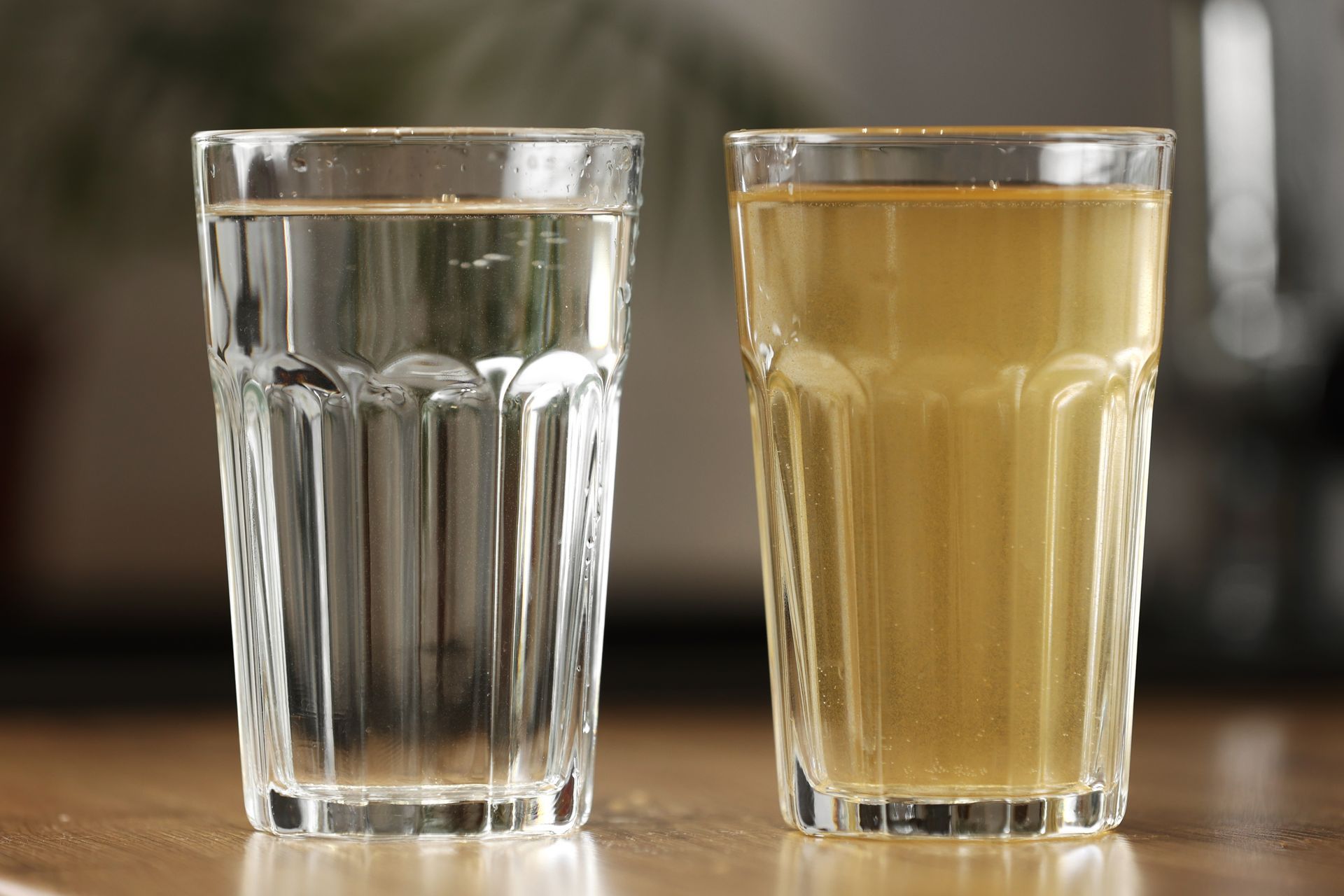 Two glasses: one clear water, the other murky brown.