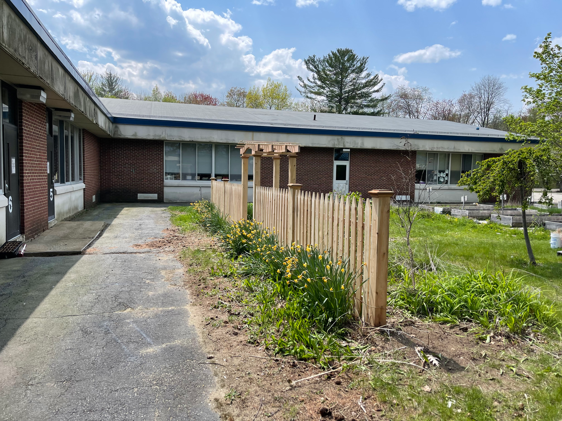 A brick building with a wooden fence in front of it