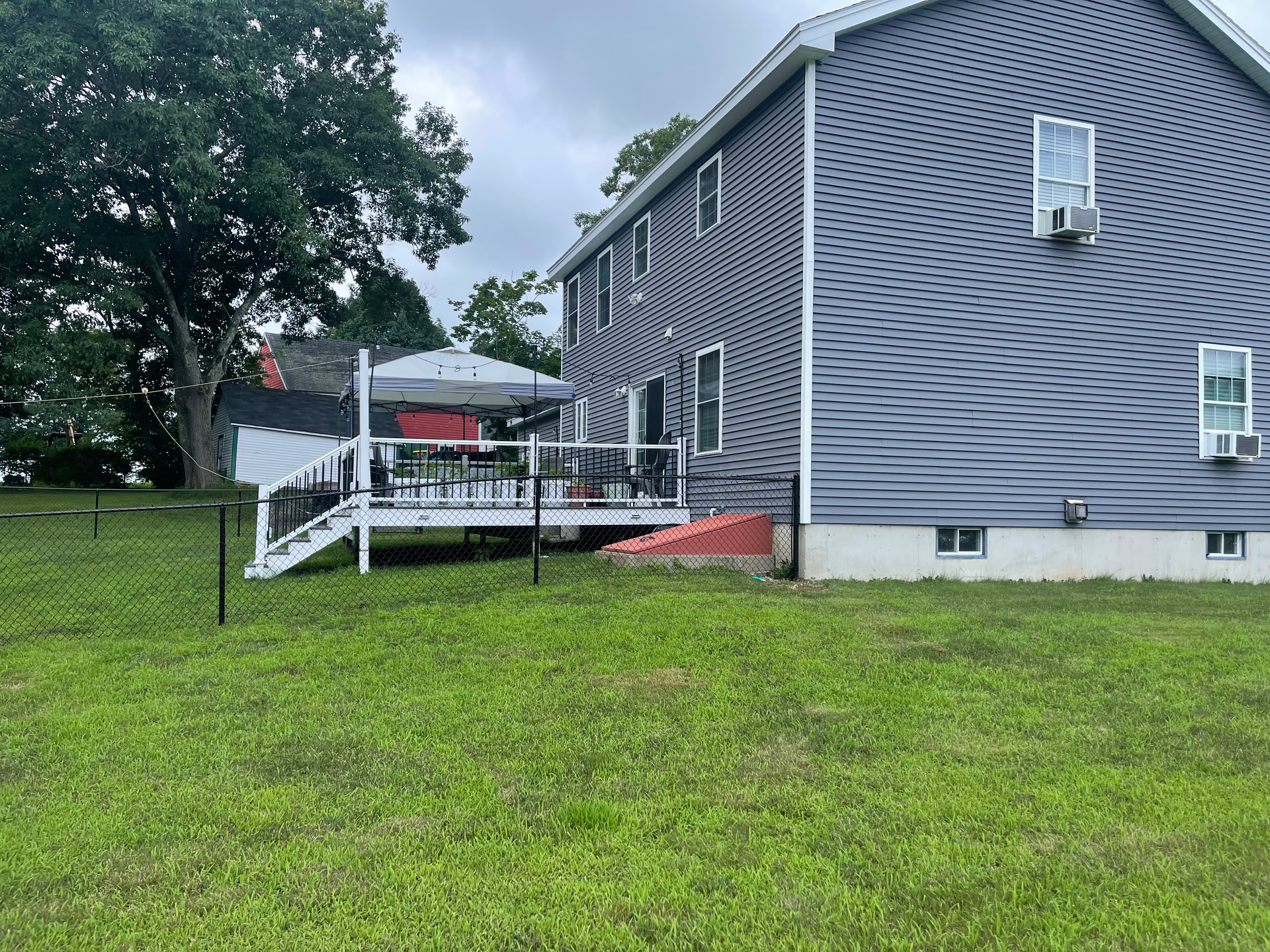 A large house with a large deck in the backyard.