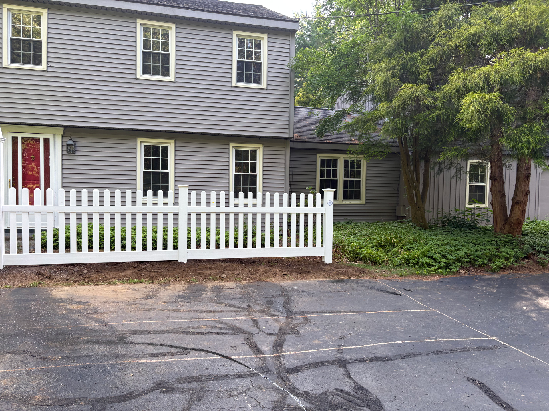 A house with a white picket fence in front of it