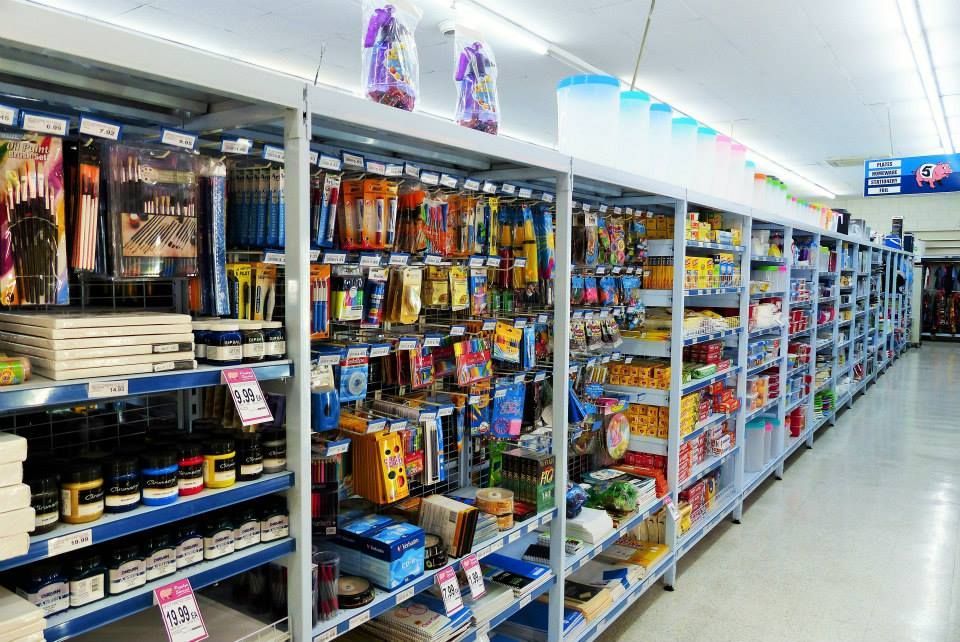 Rows of store shelves stocked with various packaged items. — Pigglys Supermarket, Takeaway & Bottle Shop in The Gap, NT