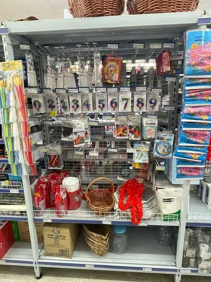 Shelves in a Store Filled With Birthday Candles, Baskets — Pigglys Supermarket, Takeaway & Bottle Shop in The Gap, NT