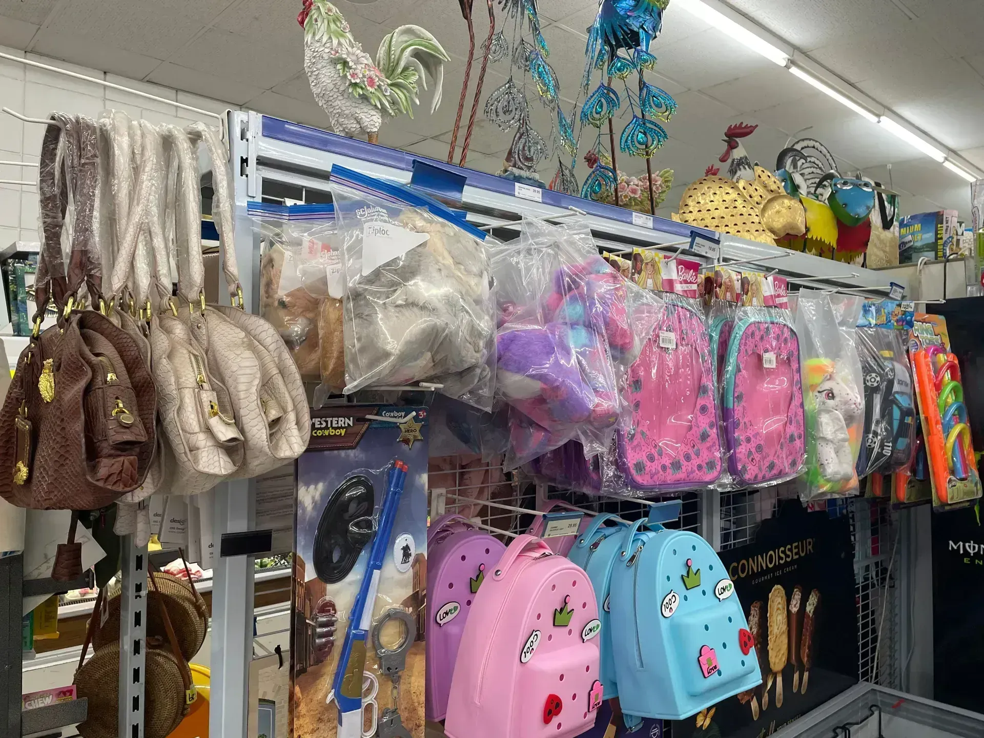 Shelves Stocked With Purses, Backpacks — Pigglys Supermarket, Takeaway & Bottle Shop in The Gap, NT