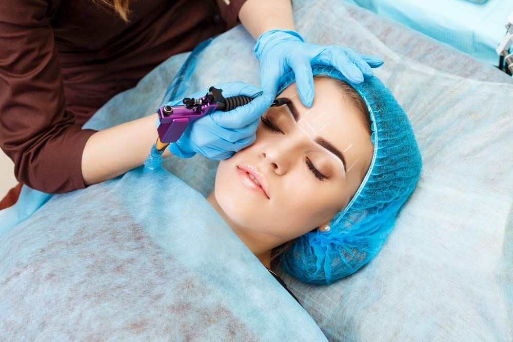 A Woman Is Getting A Tattoo On Her Eyebrows — Envy Cosmetic Collective in Maitland, NSW