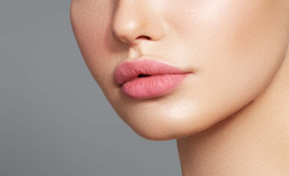 A Close Up Of A Woman's Face With Pink Lips — Envy Cosmetic Collective in Maitland, NSW