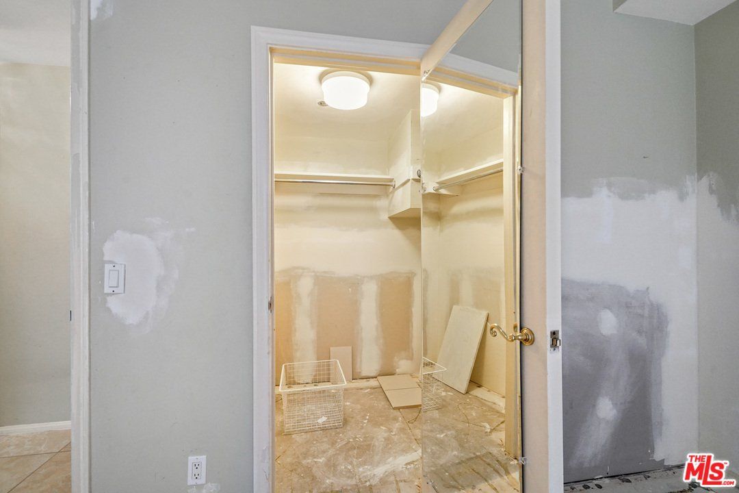 A walk in closet in a house that is being remodeled.
