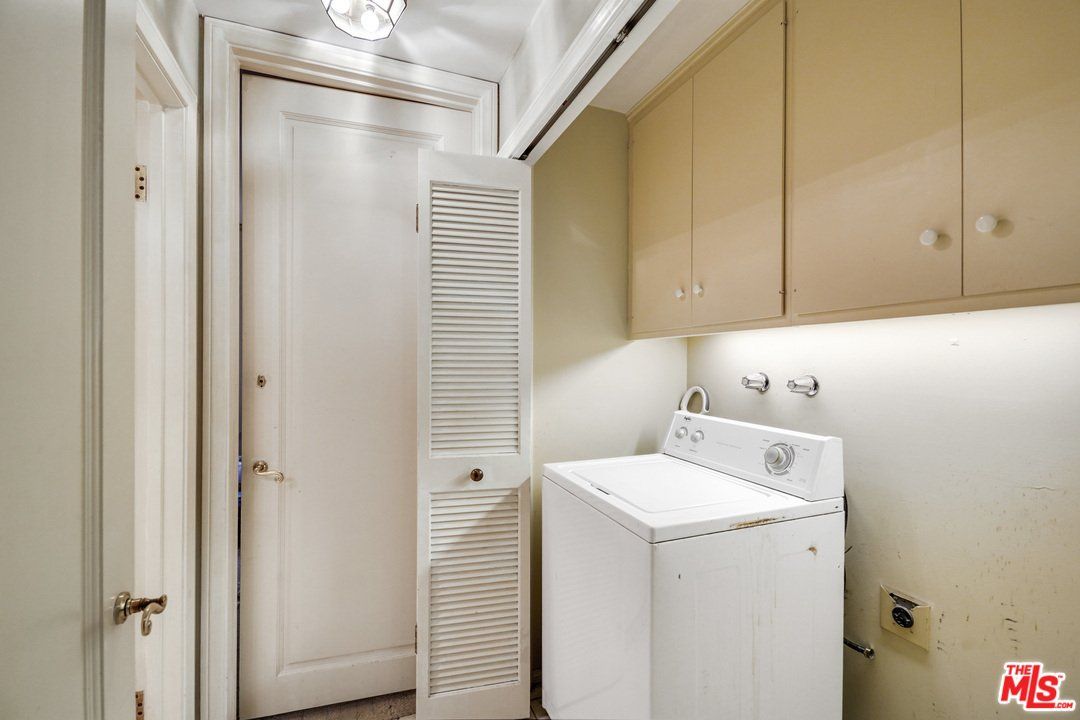A laundry room with a washer and dryer in it