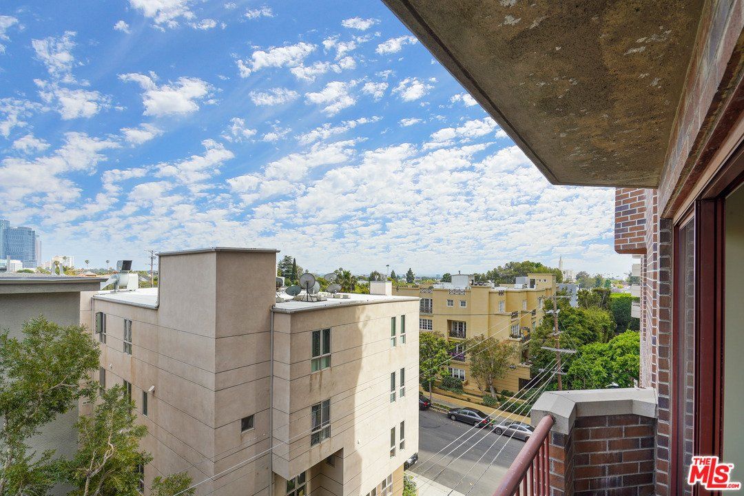 A balcony with a view of a city and buildings