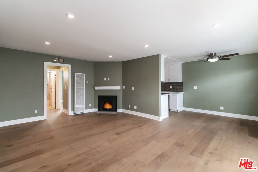 There is a fireplace in the middle of the living room.