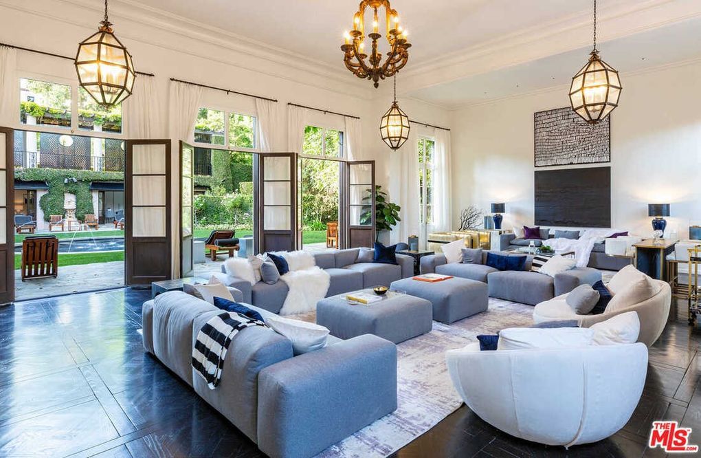 A living room filled with furniture and a chandelier.