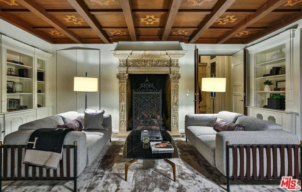 A living room with two couches , a coffee table , and a fireplace.