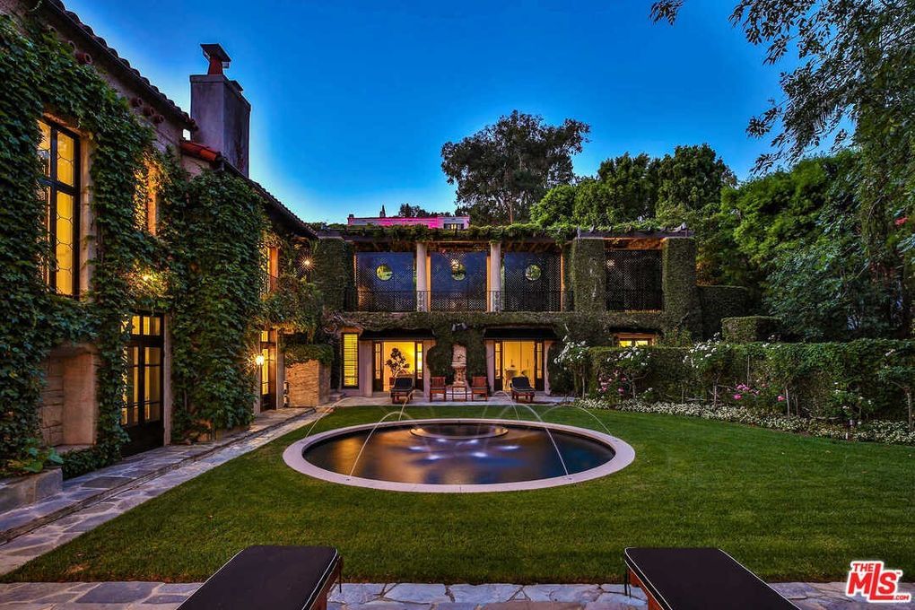 A large house with a swimming pool in the backyard