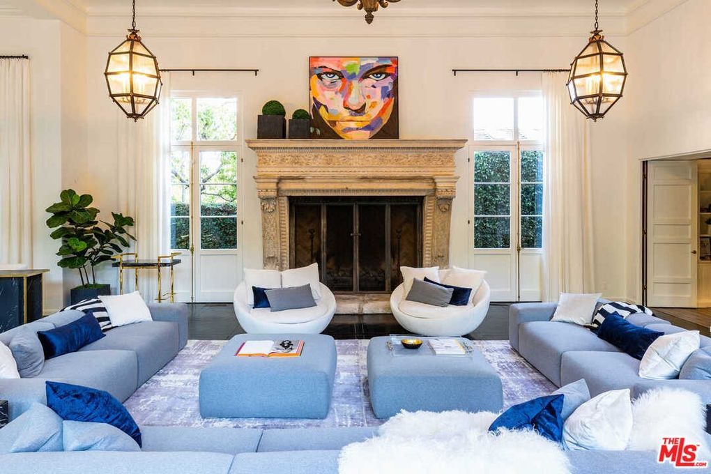 A living room filled with furniture and a fireplace.