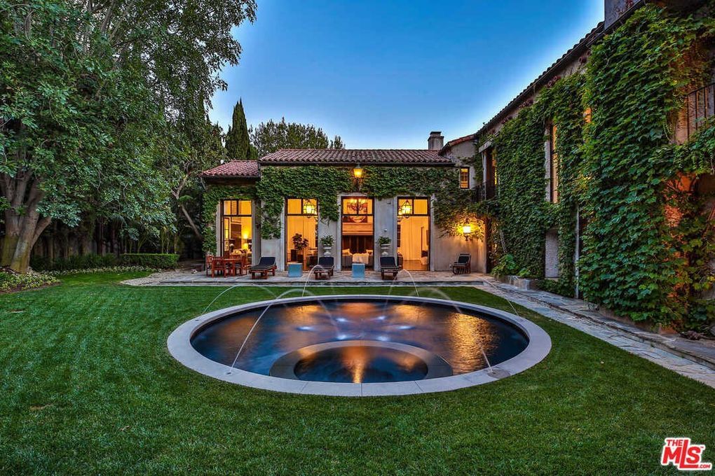 A large house with a swimming pool in the backyard.