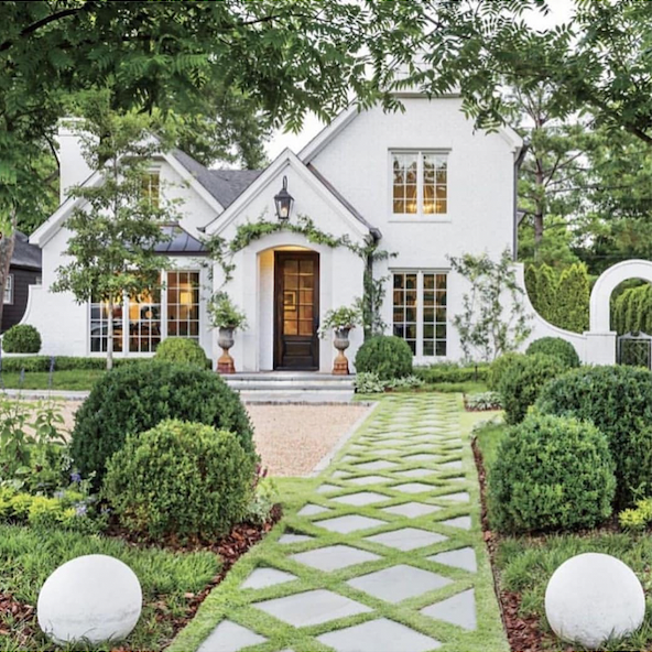 A white house with a walkway leading to it
