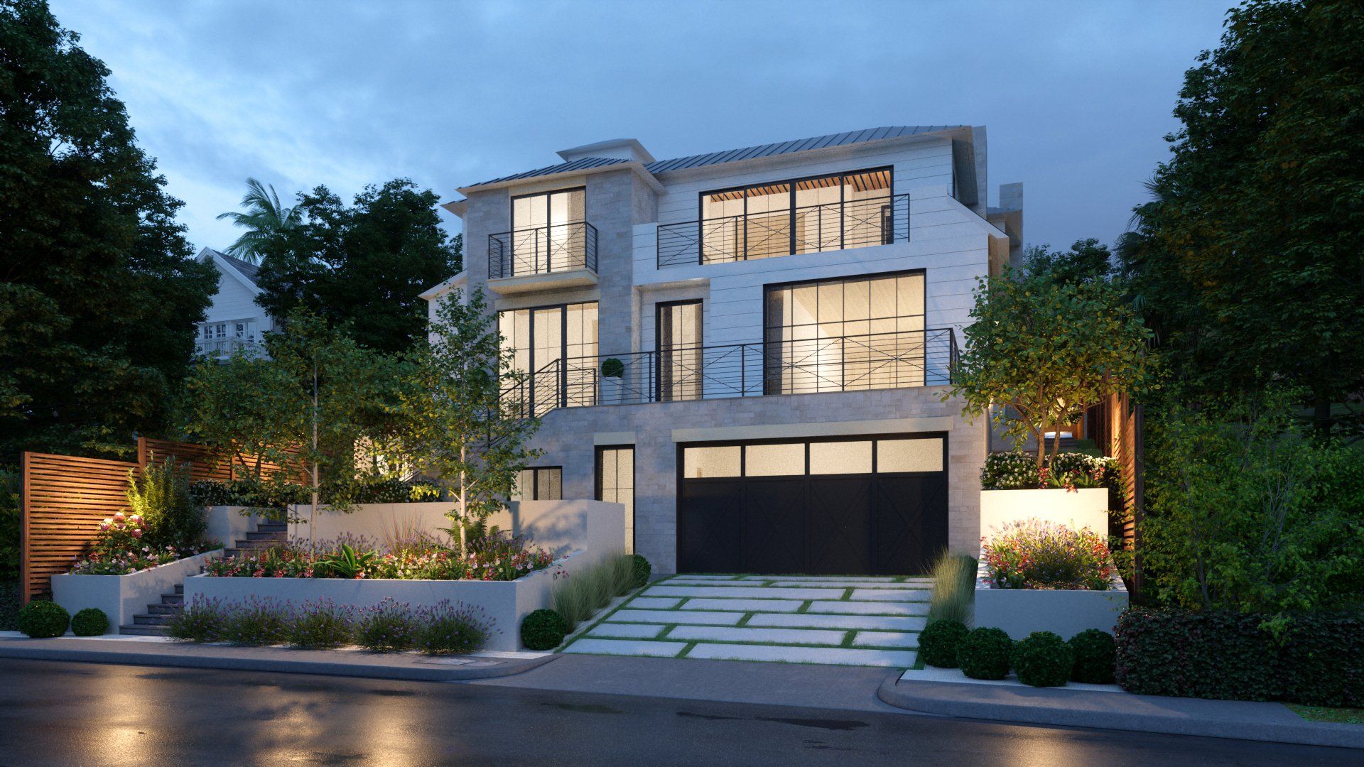 A large white house with a black garage door is surrounded by trees.