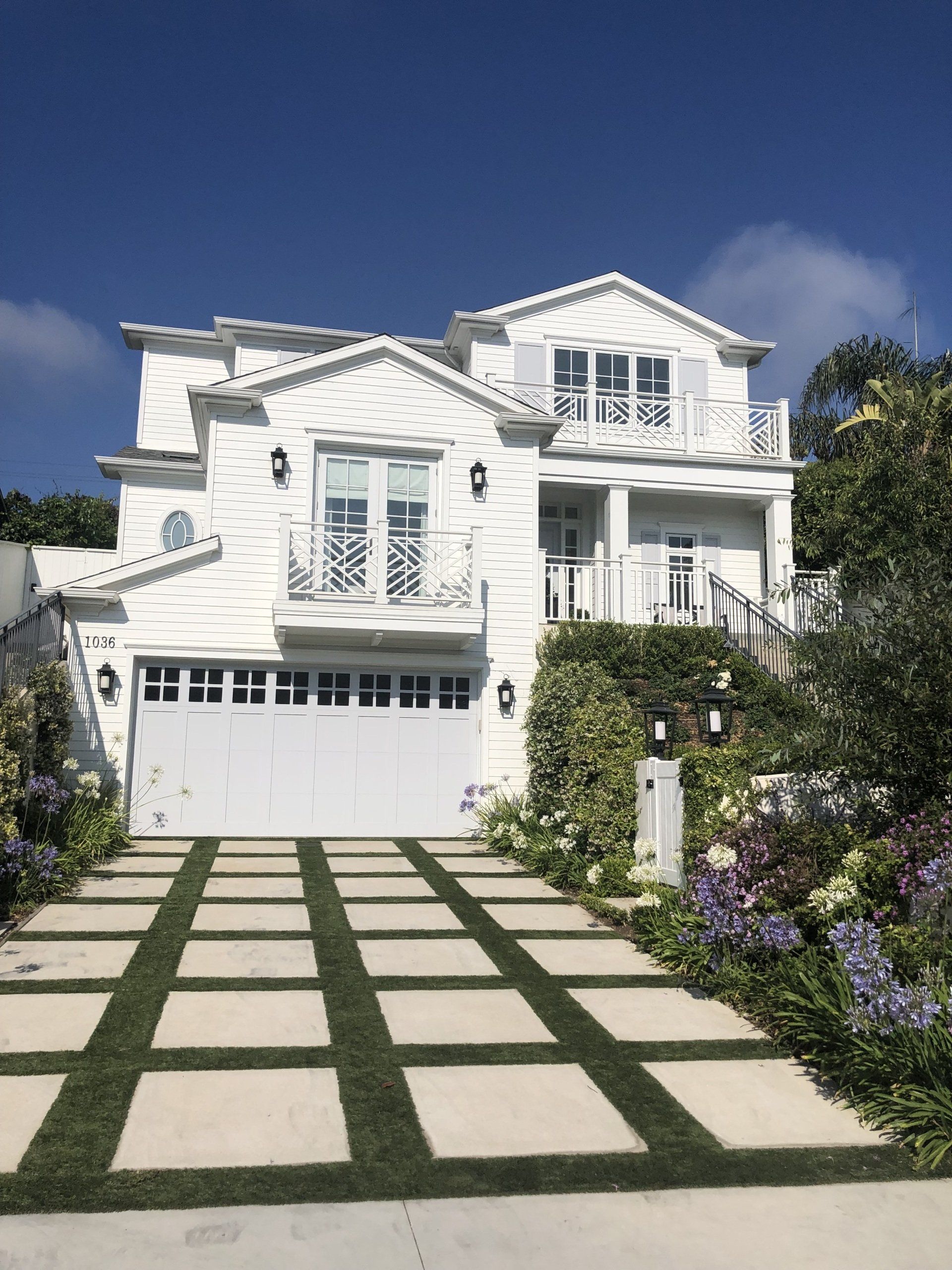 A large white house with a white garage door