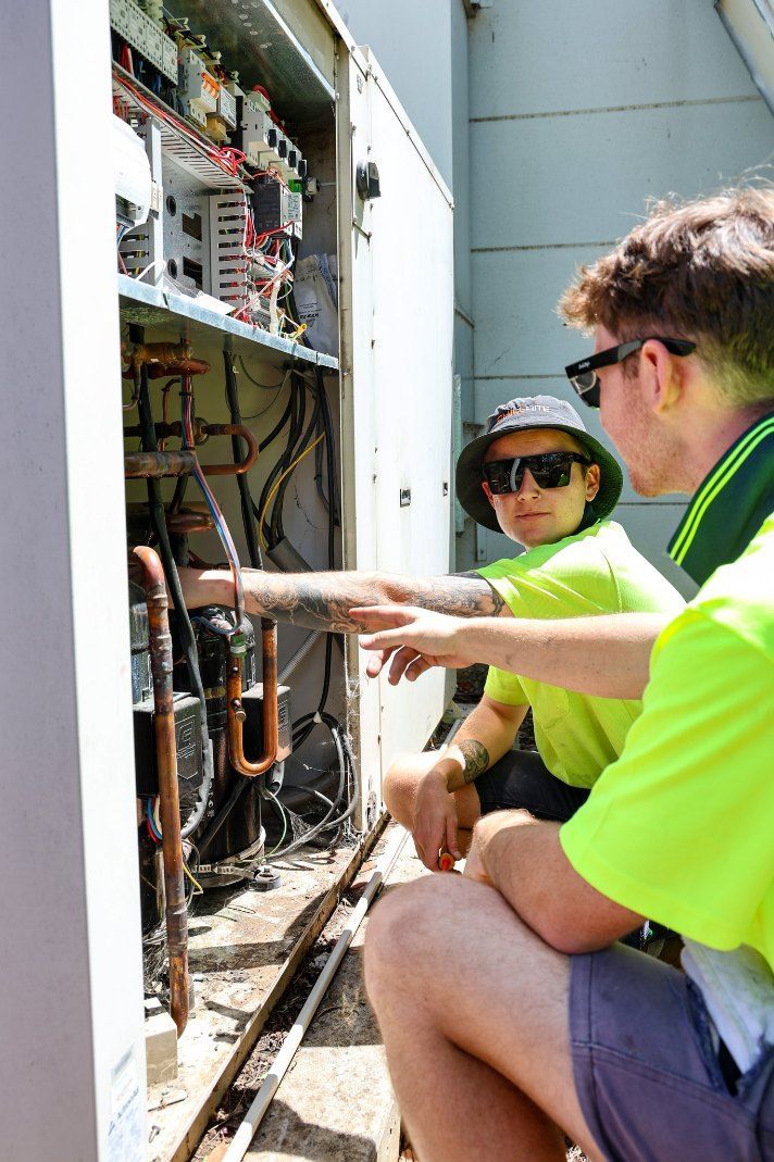 Two technicians in high vis working on a Machine — Chill-Rite Refrigeration and Air Conditioning in Dubbo, NSW