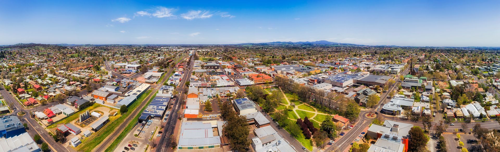 Aerial view of a city with buildings, roads, and green spaces under a blue sky— Chill-Rite Refrigeration and Air Conditioning in Newcastle, NSW