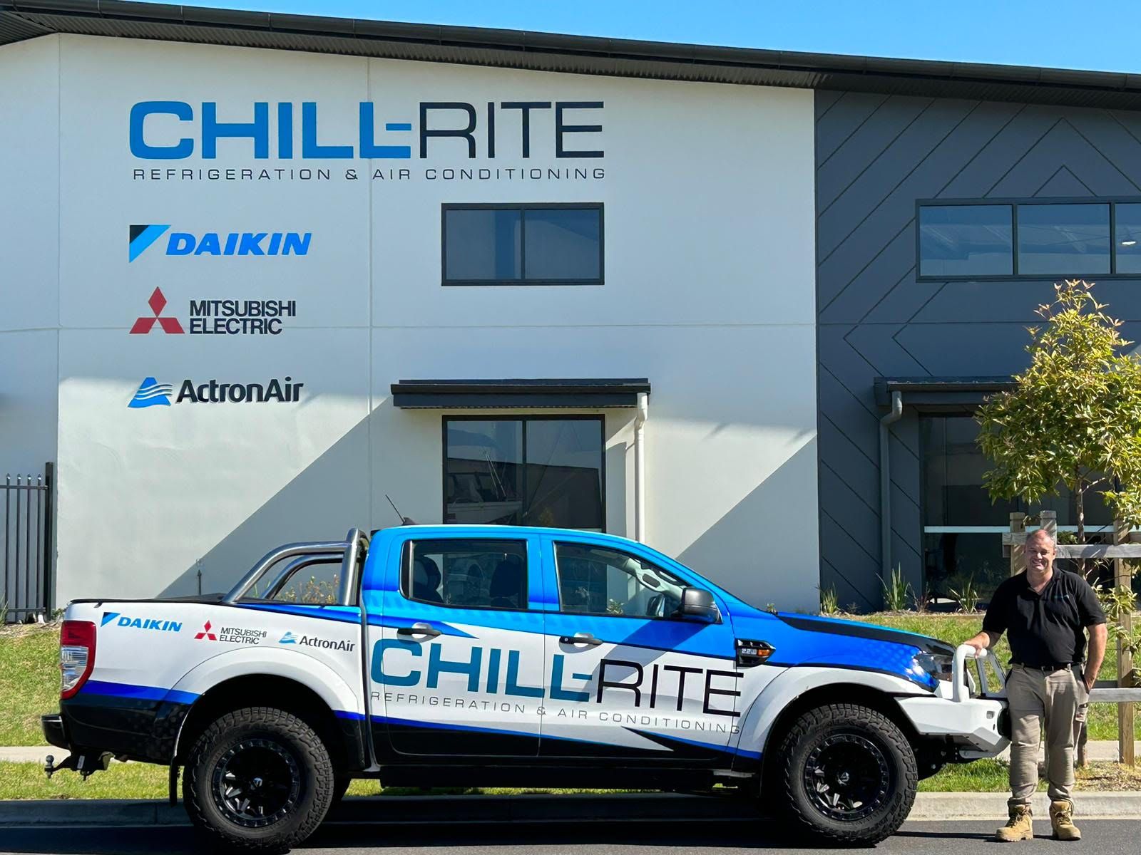 Man beside a Chill-Rite truck in front of a building with company logo and brand names— Chill-Rite Refrigeration and Air Conditioning in Newcastle, NSW
