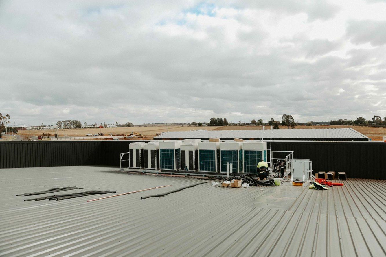 A Roof of a Building With a Ladder on It — Chill-Rite Refrigeration and Air Conditioning in Orange, NSW