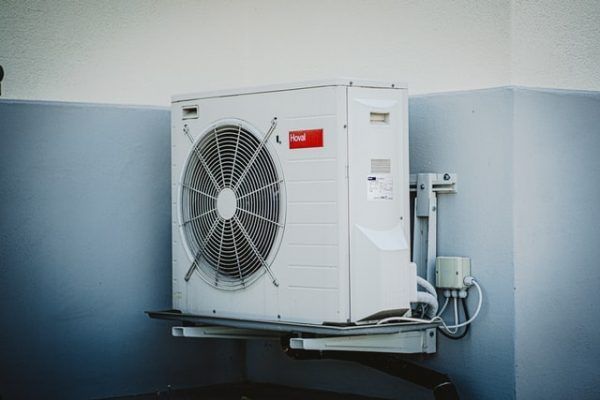 A White Air Conditioner is Mounted on a Wall — Chill-Rite Refrigeration and Air Conditioning in Dubbo, NSW