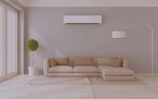 A Living Room With a Couch and Air Conditioner on the Wall — Chill-Rite Refrigeration and Air Conditioning in Dubbo, NSW