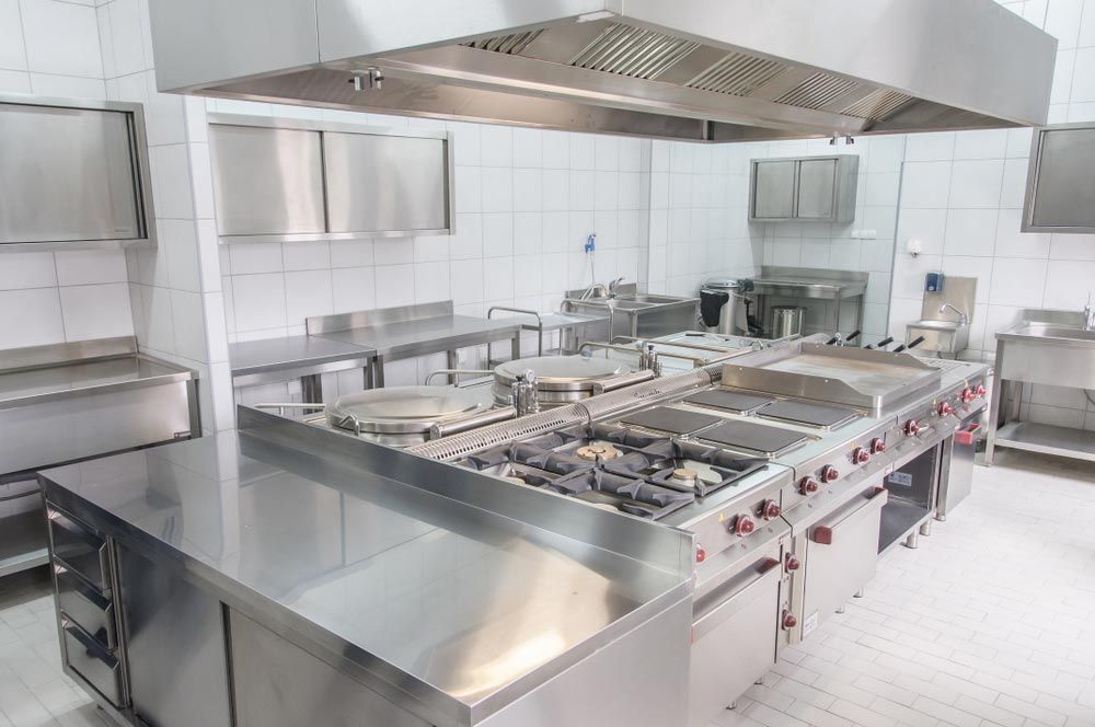 A Large Commercial Kitchen With Stainless Steel Appliances and Counter Tops — Chill-Rite Refrigeration and Air Conditioning in Dubbo, NSW