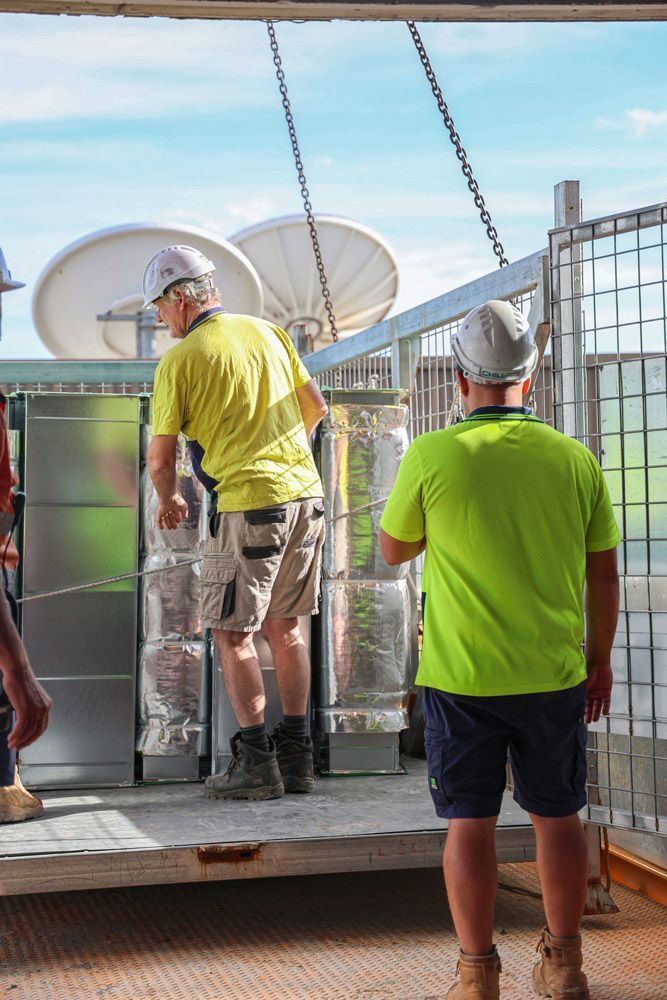Men Installing Air Conditioner System for Commercial Area