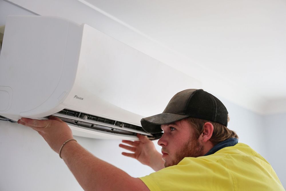 Technician Installing Air Conditioner in A House