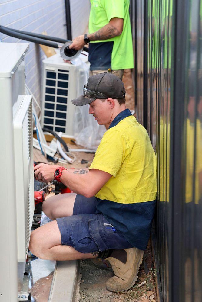 Workers in Uniform Checking Commercial Air Conditioners