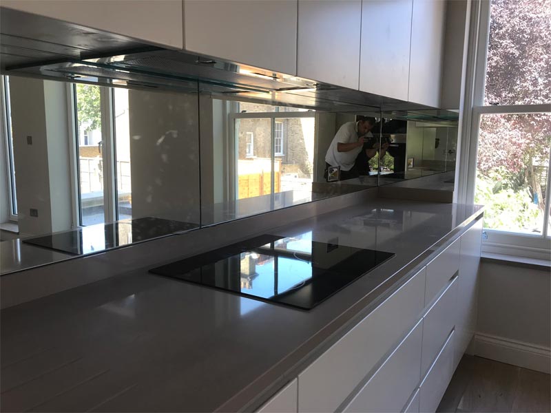 glass splashback in kitchen covering entire wall