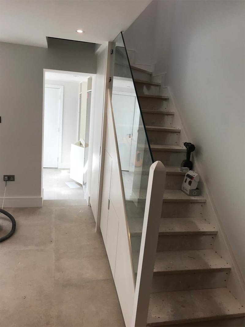 glass balustrades, white surround and undecorated stairs