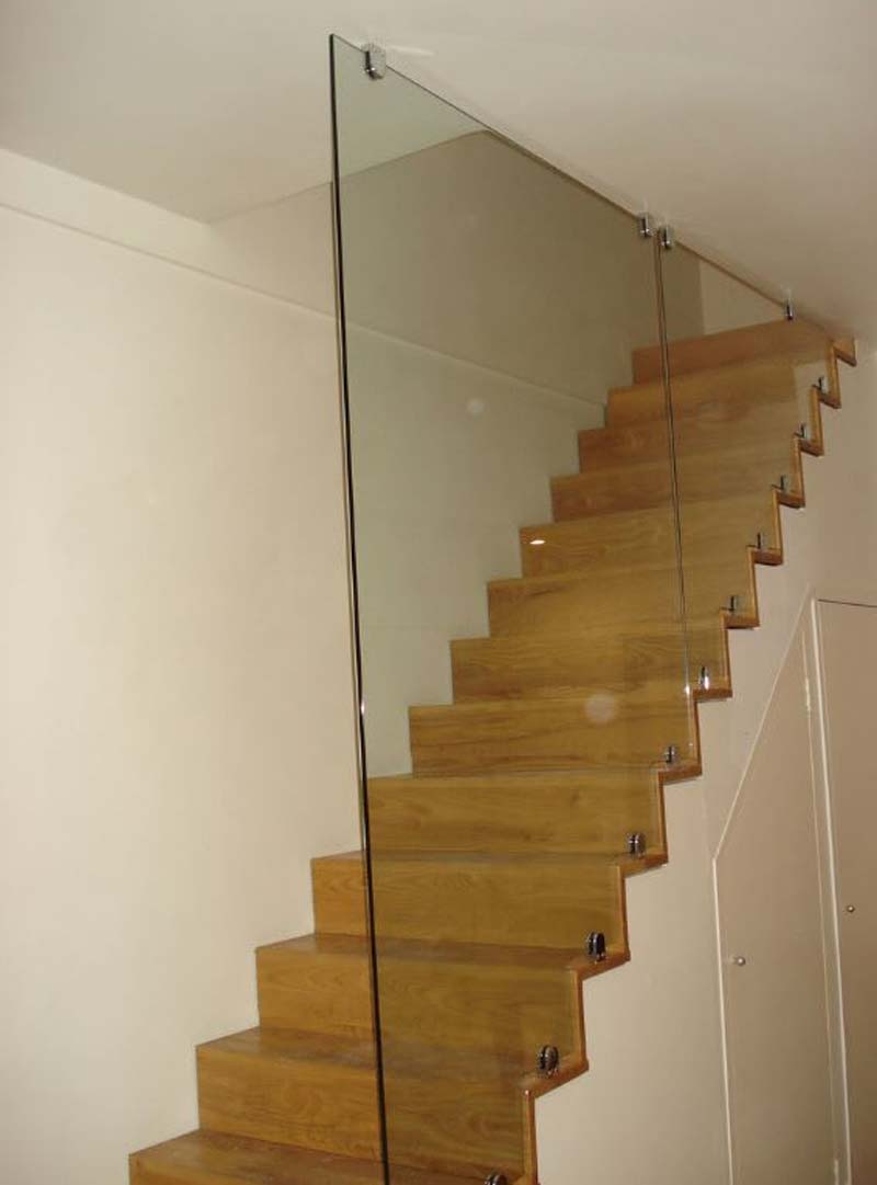glass balustrades parallel to wooden stairs