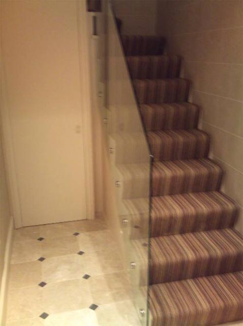 glass balustrades to left of stripy stairs