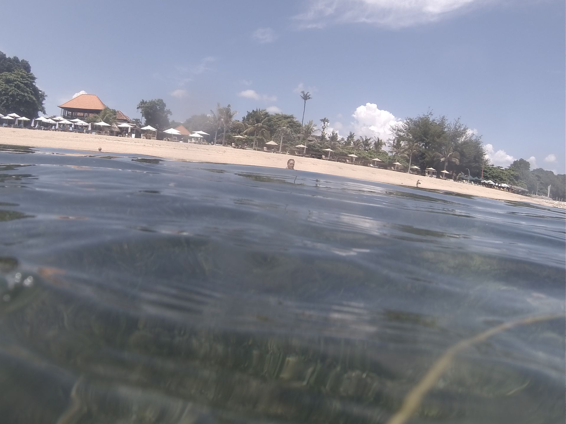 A body of water with a beach in the background