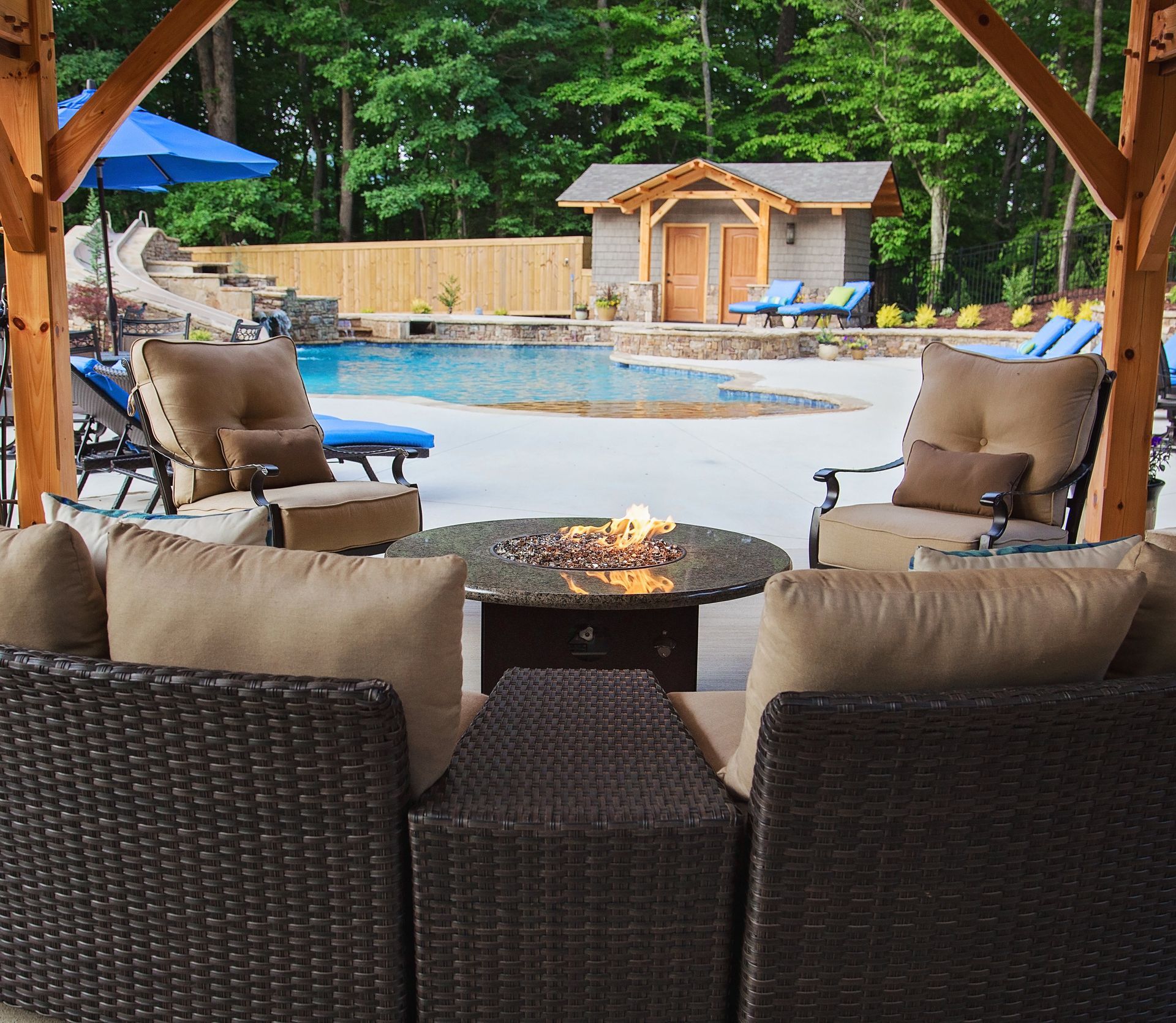 A patio area with wicker furniture and a fire pit