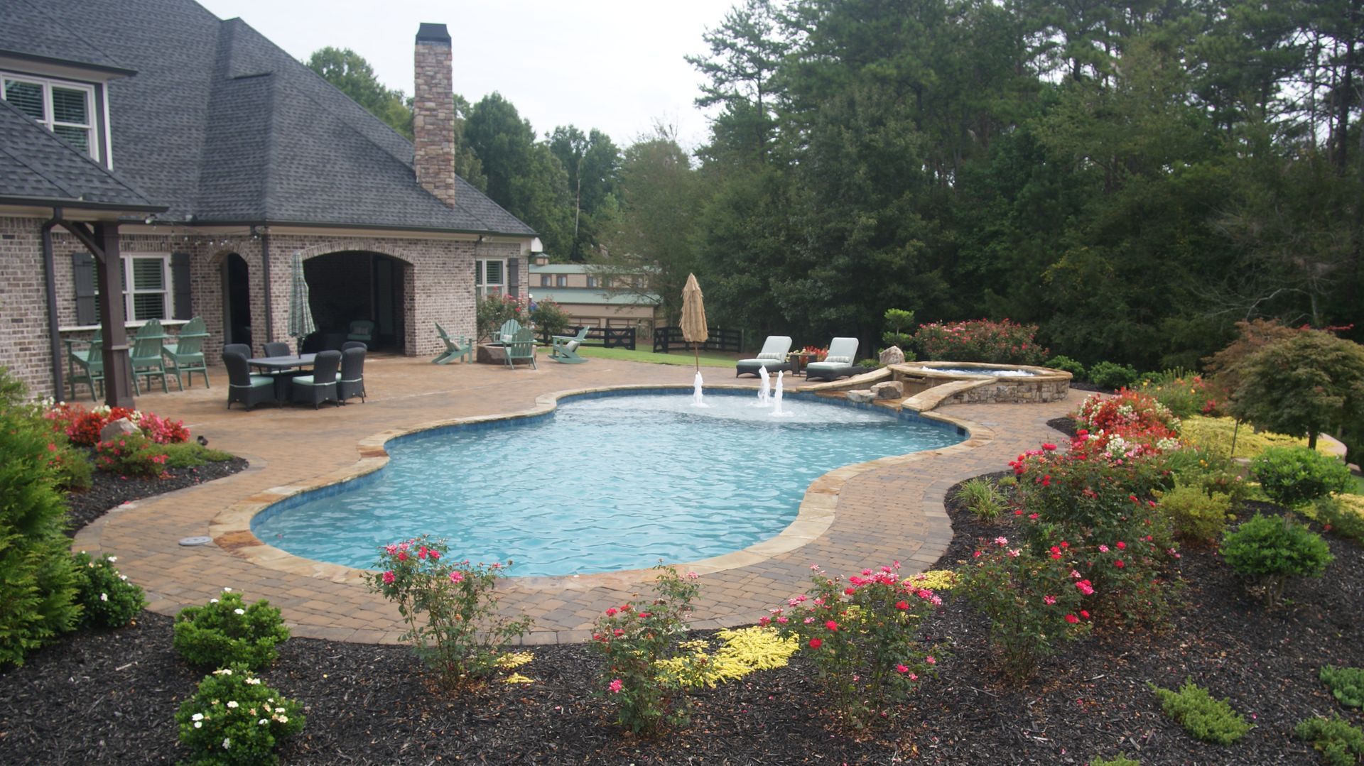 A large swimming pool in the backyard of a house