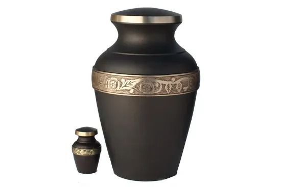 Black funeral urn with gold decorative band, shown with a smaller matching urn beside it.
