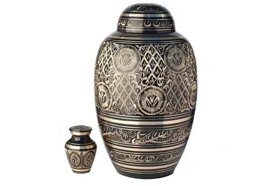 Decorative silver-and-black urn with intricate patterns, shown with a small matching vase on a white background