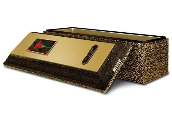 Gold and brown decorative rectangular box with a lid, viewed at an angle on a white background