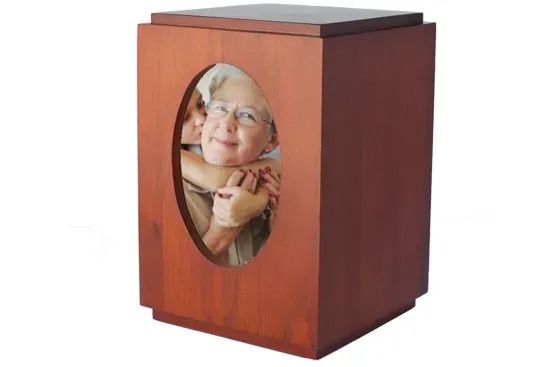 Wooden memorial urn with oval photo of a smiling person on the front