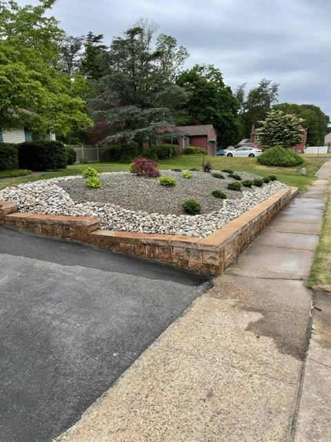 A driveway with a garden in the middle of it