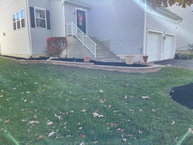 A white house with stairs leading up to the front door