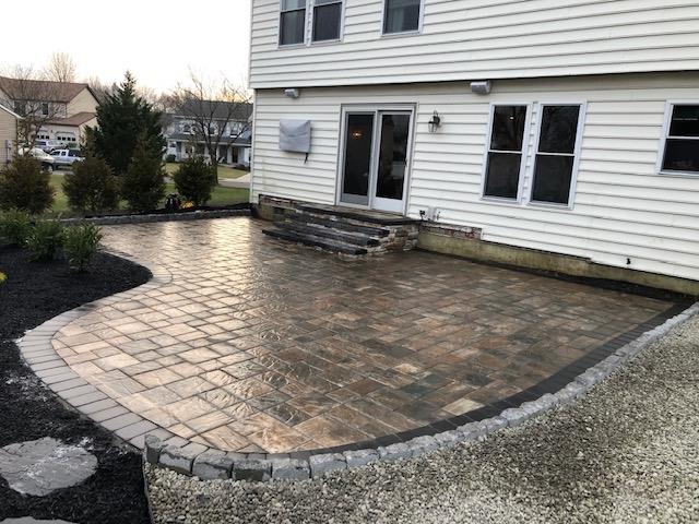 A large white house with a patio in front of it.