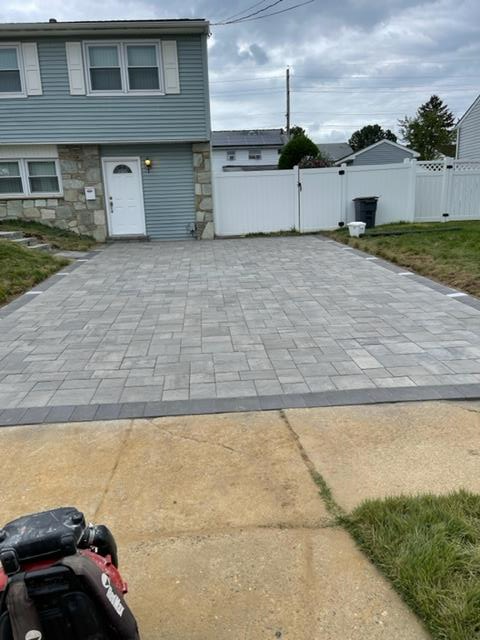 A lawn mower is parked in front of a house
