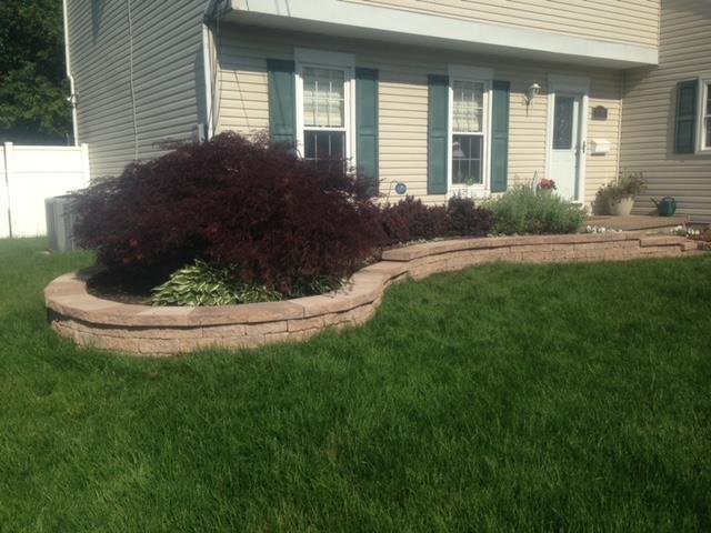 A house with a lush green lawn in front of it