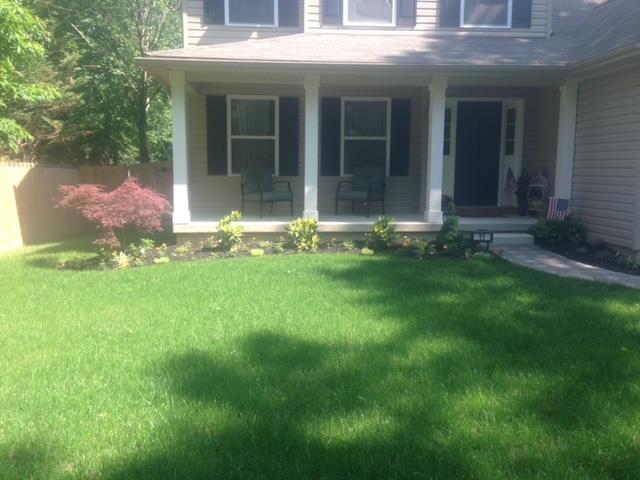 A house with a large lawn in front of it